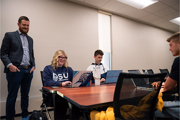 Students working in a classroom with Professor Dr. Andy Behrens.